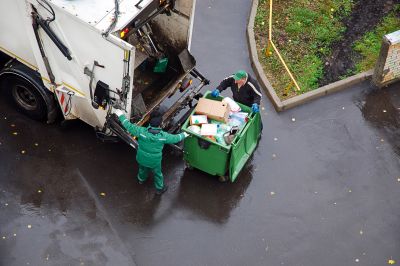 Waste management truck at curbside